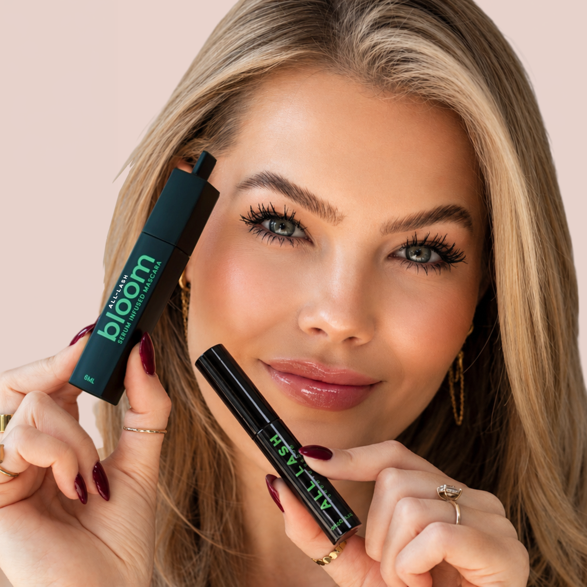 Model holding the ALL-LASH Lash Serum & Mascara Duo Set featuring Eyelash Growth Serum and Bloom Serum Infused Mascara for naturally longer, fuller-looking lashes